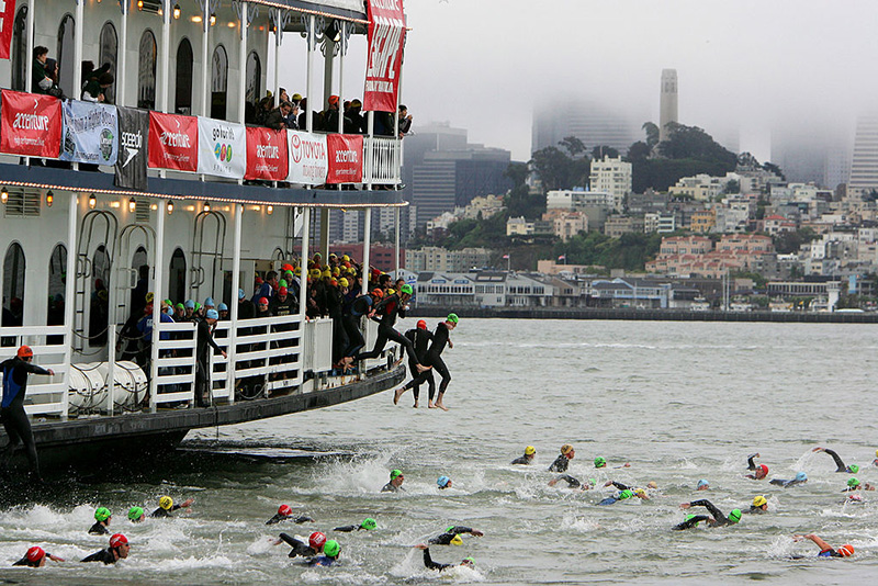 Athletes jump into the San Francisco Bay in front of Alcatraz island at the start of the Escape from Alcatraz Triathlon in San Francisco, California. (Photo by Jed Jacobsohn/Getty Images)