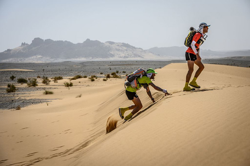 People compete in the Marathon des Sables between Kourci Dial Zaid and Jebel El Mraïer in the southern Moroccan Sahara desert. (Photo credit JEAN-PHILIPPE KSIAZEK/AFP via Getty Images)