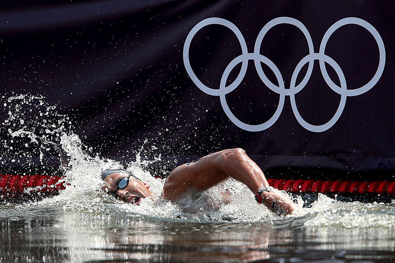Oussama Mellouli of Tunisia competes in the Men's Marathon 10km swim on Day 14 of the London 2012 Olympic Games at Hyde Park on August 10, 2012 in London, England. (Photo by Alexander Hassenstein/Getty Images)