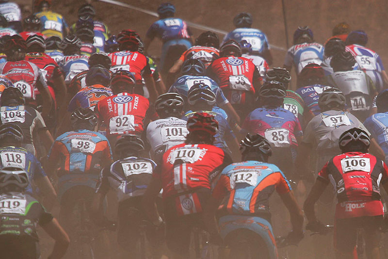 Competitors enter the course in a cloud of dust during the Men's Cross Country Race at the UCI Mountain Bike World Cup at the Angel Fire Resort on July 10, 2005 in Angel Fire, New Mexico. Christoph Sauser #1 from Switzerland went on to win the race. (Photo by Doug Pensinger/Getty Images)