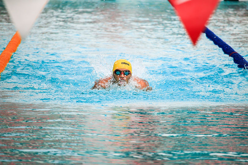 Man swimming in pool. Photo by Jim De Ramos