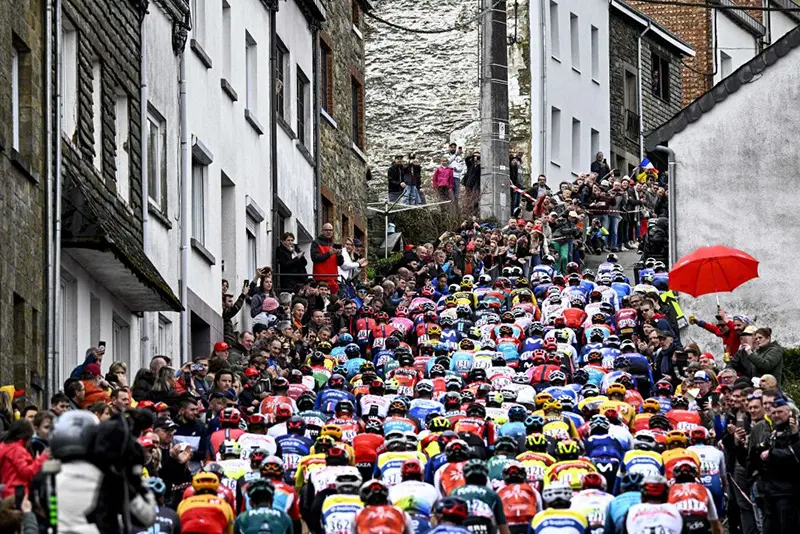The pack of riders cycles during the men's elite race of the Liege-Bastogne-Liege one day cycling event, 258,5 km round-trip from Liege via Bastogne. (Photo by JASPER JACOBS/Belga/AFP via Getty Images)