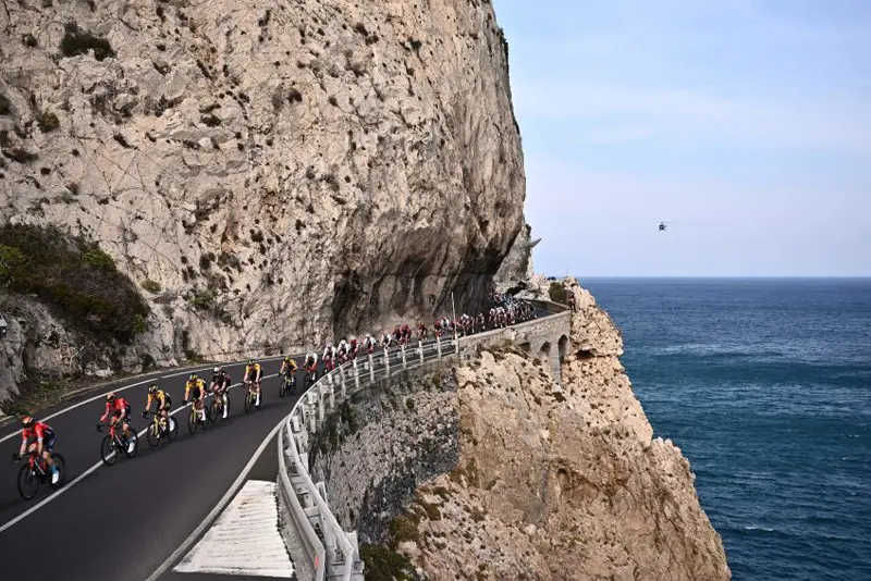 The pack rides along the coastline near Varigotti, Liguria, during the Milan-San Remo one-day classic cycling race between Milan and San Remo, northern Italy. (Photo by MARCO BERTORELLO/AFP via Getty Images)