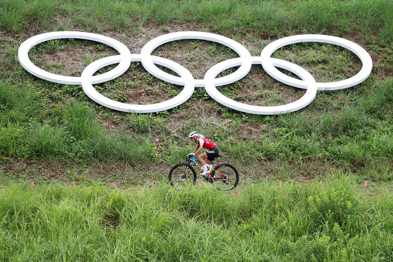 A general view Jolanda Neff of Team Switzerland rides and at the bottom you can see the Olympic symbols during the Women's Cross-country race on day four of the Tokyo 2020 Olympic Games at Izu Mountain Bike Course on July 27, 2021 in Izu, Shizuoka, Japan. (Photo by Michael Steele/Getty Images)