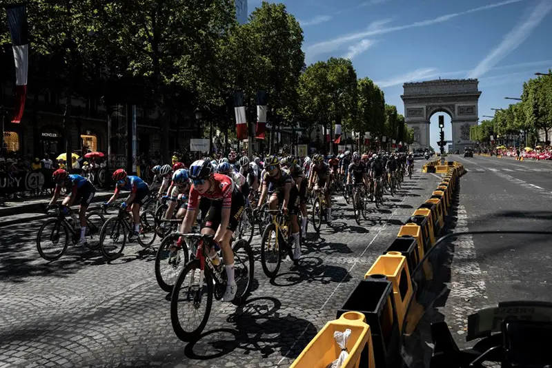 The pack rides past the Arc de Triomphe during the 1st stage of the Women's Tour de France cycling race, 81,6 km between the Tour Eiffel and the Champs-Elysees, in Paris. (Photo by JEFF PACHOUD/AFP via Getty Images)
